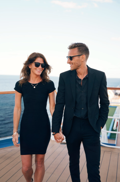 black on black suit: couple on boat