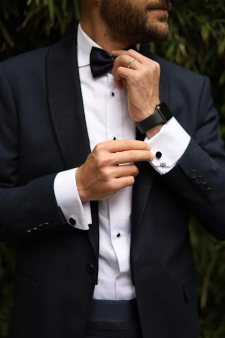 semi formal vs cocktail: man adjusting cufflinks